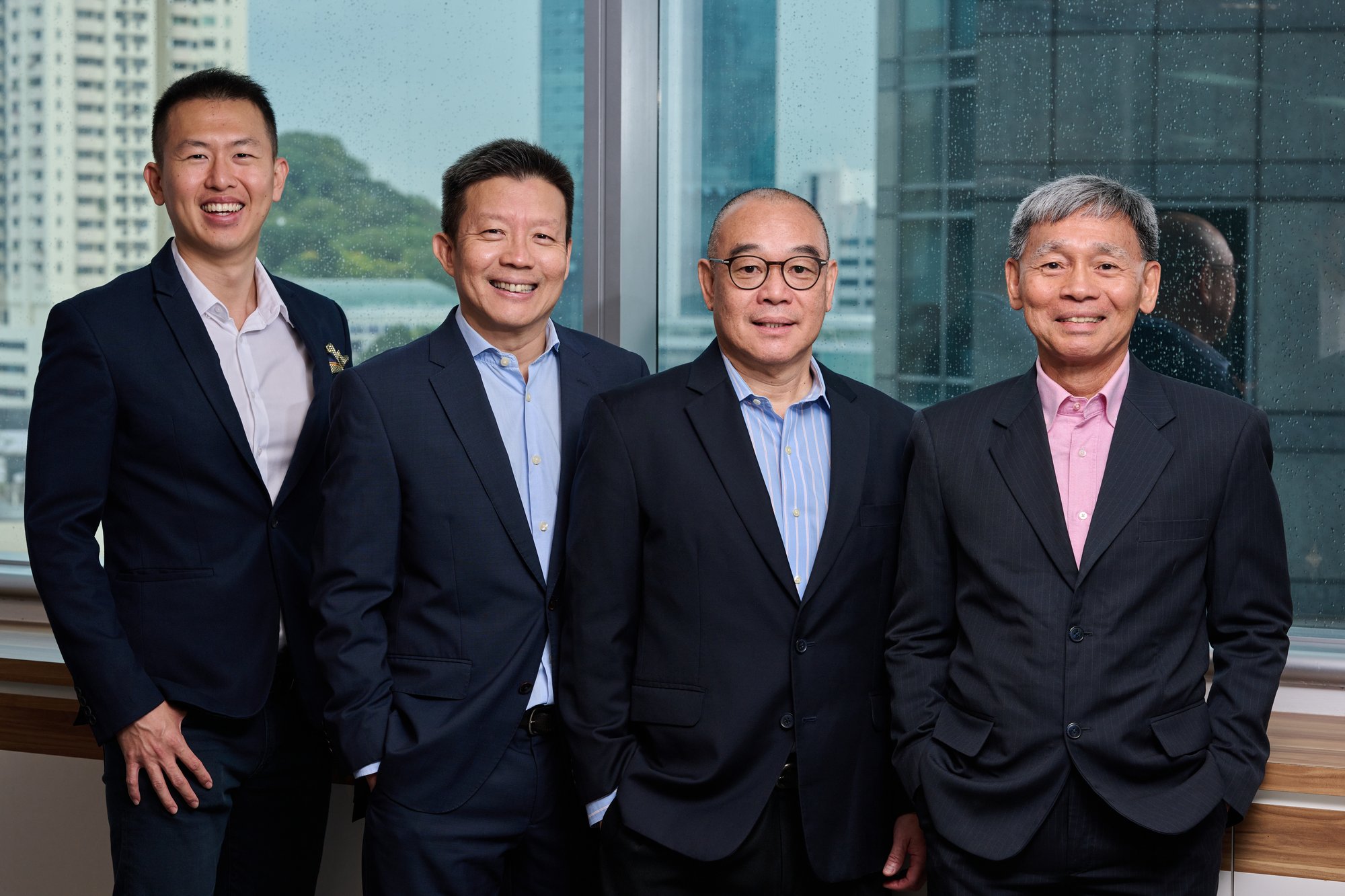 Aura Private Wealth Singapore team standing together against a city background