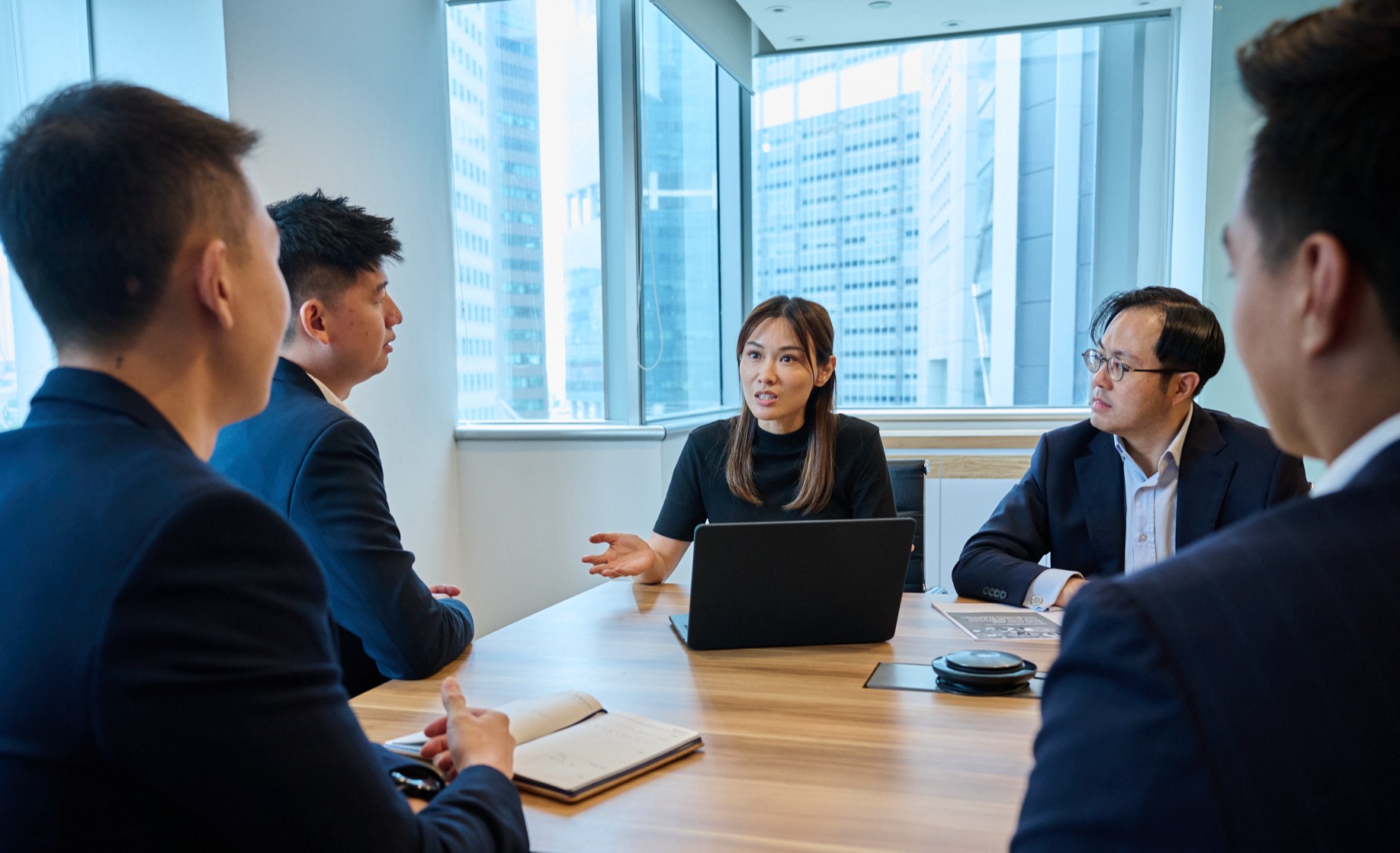 Aura Group Singapore team sitting around a meeting room table