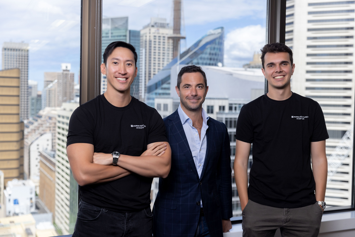 Aura Ventures Australia group photo standing with arms crossed against Sydney buildings
